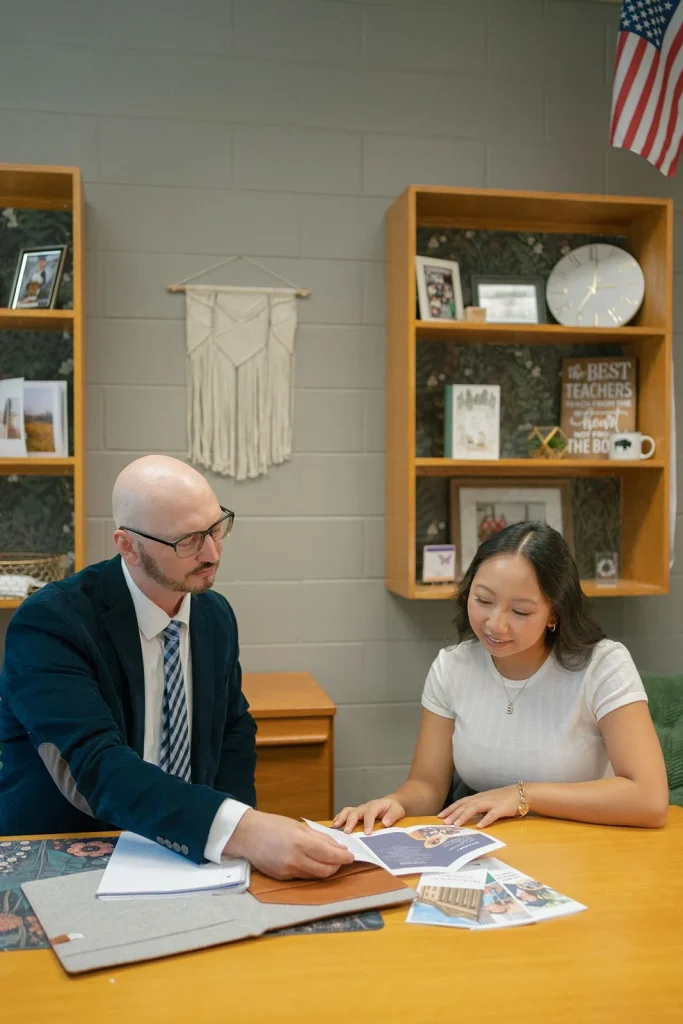 A student reviews written guidance with an adviser.